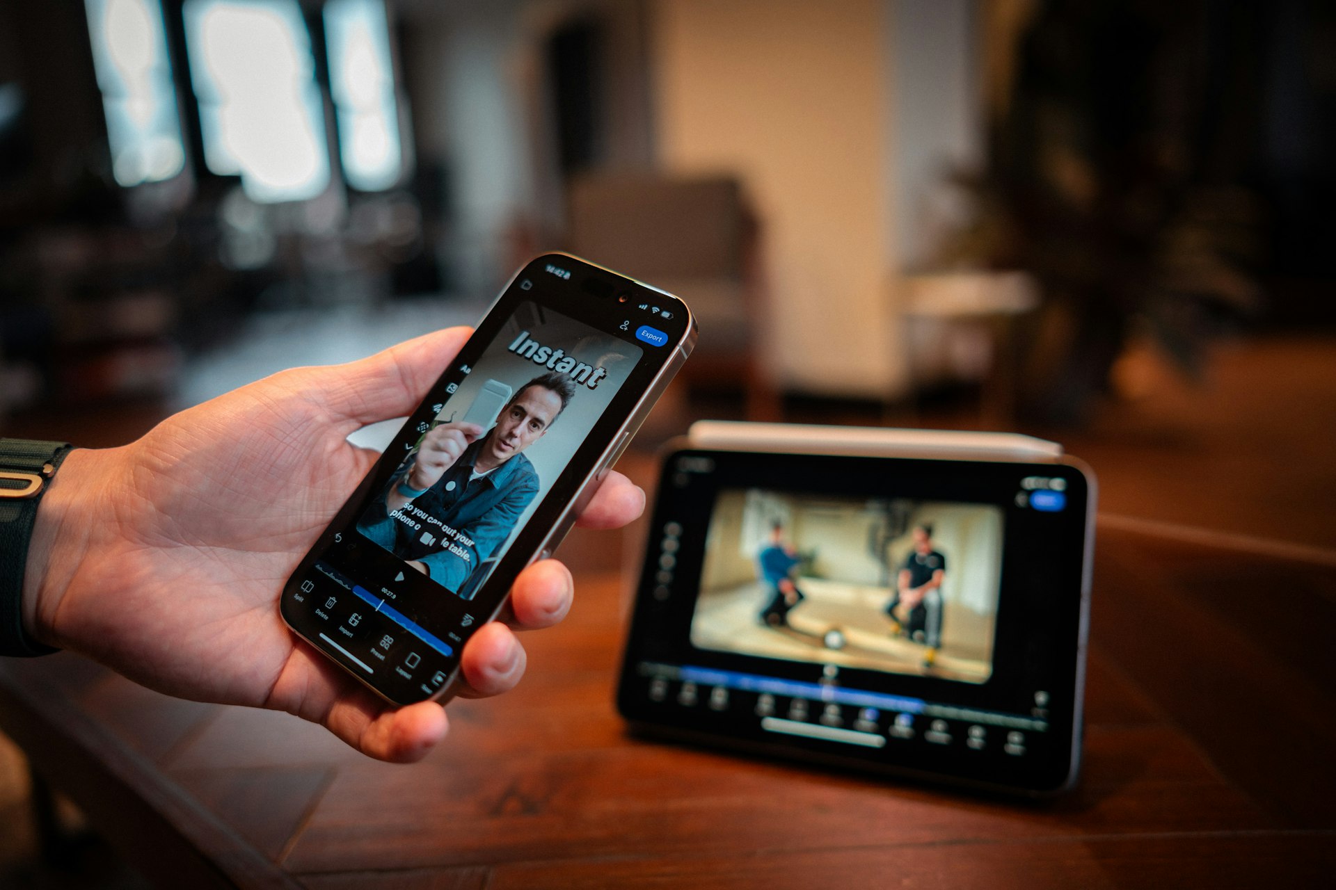 Person holding smartphone showing video content